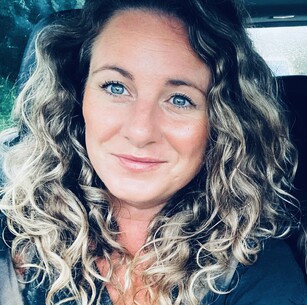 Holly Scott owner of Harvest with blonde, textured, wavy hair with a fringe wearing bohemian jewellery.