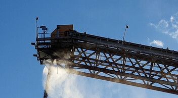 Dust suppression water spray on conveyor belt stacker