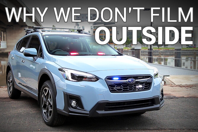 Title - Why We Don't Film Outside. Blue Subaru XV SUV with REDFLEET warning lights in grille and on dashboard, parked near river
