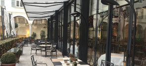 A beautiful courtyard ready for outdoor dining in winter with the addition of the stylish black floor-standing heaters.