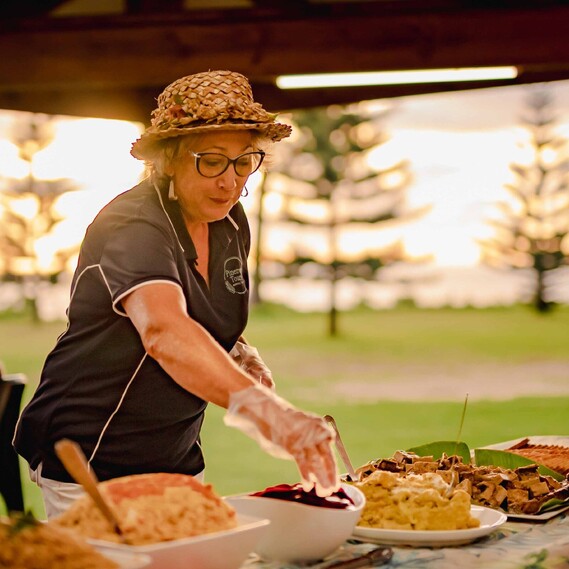 Woman preparing food outdoors
