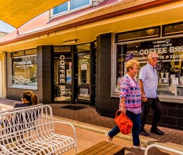 Village walk with shops and seating areas