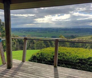 deck and view below to the valley and dramatic cloudy skies