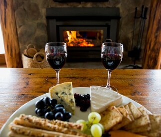 cosy fire with red wine and cheese plate