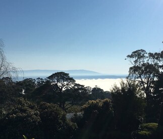 distant mountains and blue sky with foggy vally below