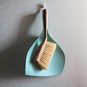 Broom for cleaning hanging up on wall