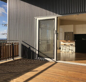 View from deck above carport into dining room and kitchen.