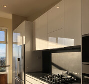 Custom kitchen design featuring two-pac painted panels, honed black and polished Blue Pearl granite.