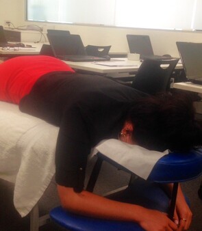 Lady lying on massage table from Mobile Healing Hands