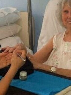 An elderly lady receiving a manicure from Mobile Healing Hands