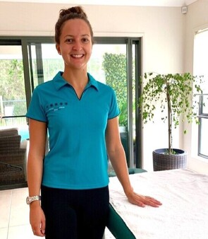 Remedial Table Massage therapist from Mobile Healing Hands next to massage table