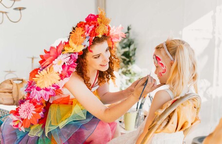 Rainbow fairy doing face painting