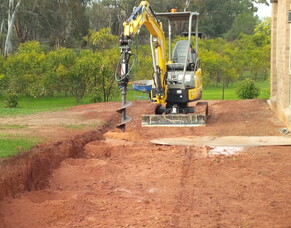 How to use a mini excavator and post hole auger