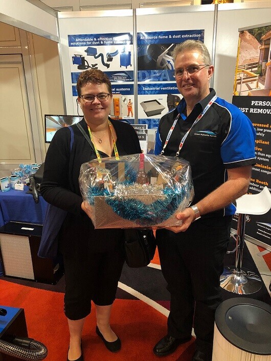 Greg Albert from Dynamic Engineering Australia presents Jenny from Coffey, Northern Territory, with winning hamper.