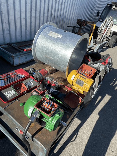 The tools of a ventilation engineer required to replace a motor fan for a client