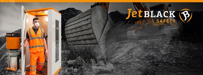 JetBlack Safety personnel cleaning booth with man exiting the booth (with mask on), and background image of mining/dusty work environment