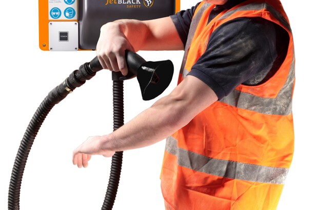 Close up shot of a worker using a JetBlack Safety wall mounted personnel cleaning station on his skin (showing safe to use)