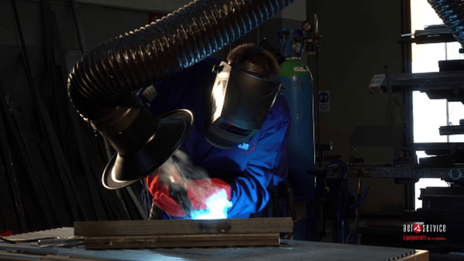 An Aerservices at-source fume extraction arm being used while a worker is welding