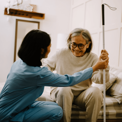 Nurse helping a blind person at home