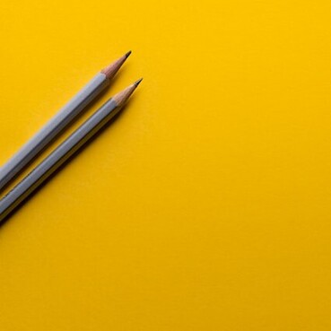 Pencils on a yellow background.